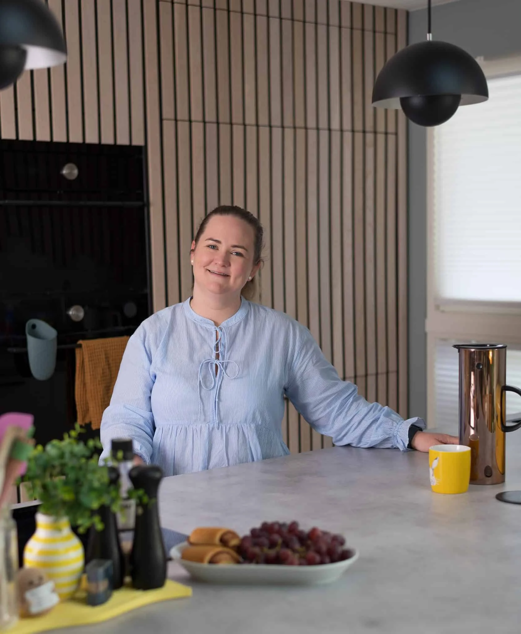 Evig minne portrett av kvinne i kjøkkenet, smilende og avslappet, med moderne interiør og naturlig l.